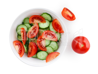 Sliced tomatoes and cucumbers on a white plate