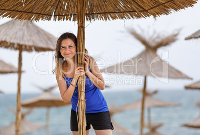 Woman and straw umbrella