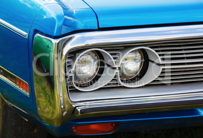 Headlights of blue car