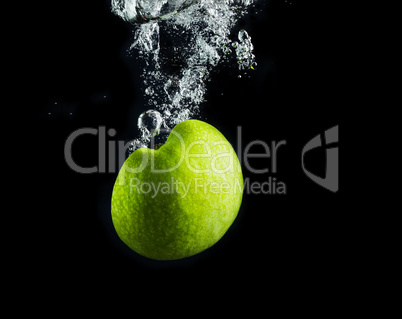 Green apple in water