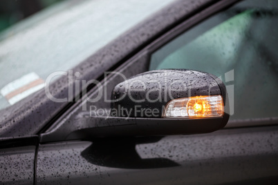 Car mirror with rain drops