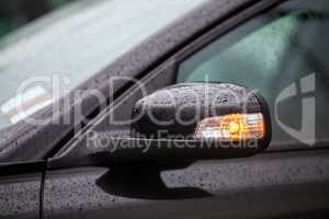 Car mirror with rain drops