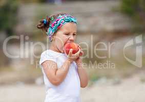 Baby girl eats a peach