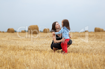Mom and daughter in a field
