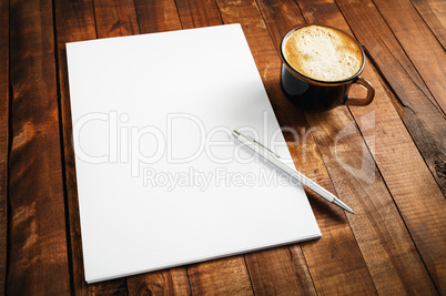 Photo of blank letterhead, coffee cup and pen