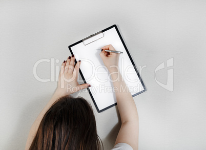 Woman writes on blank paper