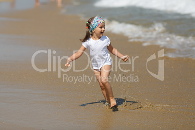 Child runs along the beach