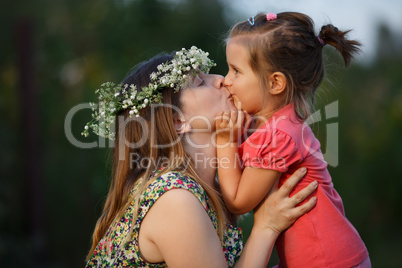 Kiss of mother and daughter