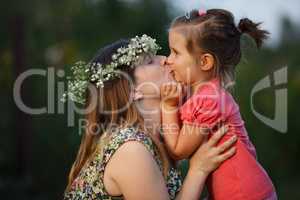 Kiss of mother and daughter