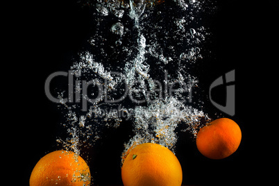 Fresh oranges in water