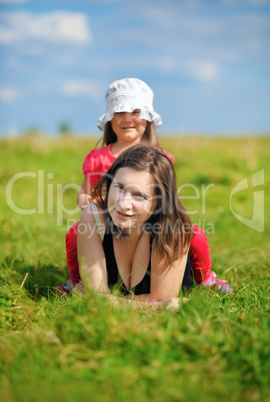 Mom and daughter on a meadow