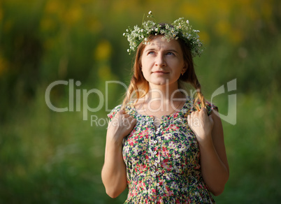 Young woman with a wreath looking up