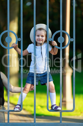 Child behind a fence