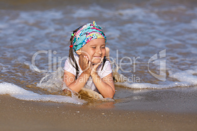 Child resting on the beach