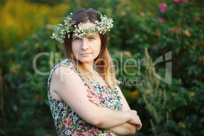 Pretty young woman with wreath on head