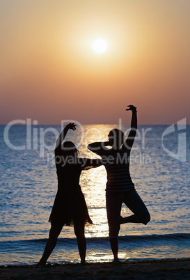 Girls dancing at sunset