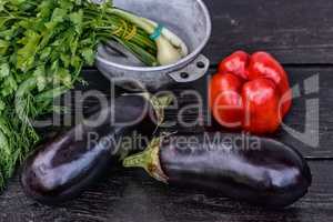 Set of fresh vegetables on dark wood table background. Still life photography.
