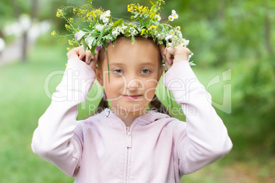 Portrait of a girl with a wreath of flowers on her head