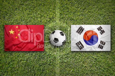 China vs. South Korea flags on soccer field