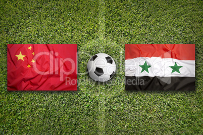 China vs. Syria flags on soccer field