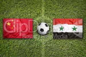 China vs. Syria flags on soccer field