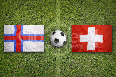 Faeroe Islands vs. Switzerland flags on soccer field