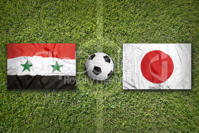 Iraq vs. Japan flags on soccer field