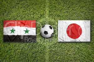 Iraq vs. Japan flags on soccer field