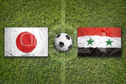 Japan vs. Iraq flags on soccer field