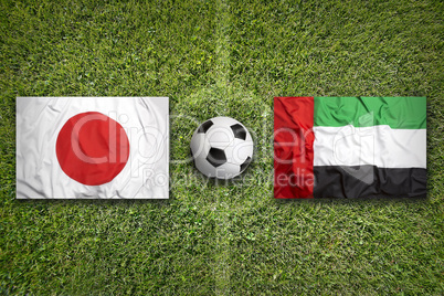 Japan vs. United Arab Emirates flags on soccer field