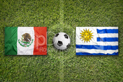 Mexico vs. Uruguay flags on soccer field