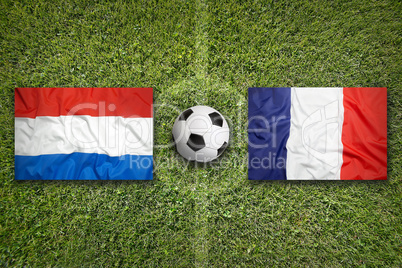 Netherlands vs. France flags on soccer field