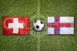 Switzerland vs. Faeroe Islands flags on soccer field