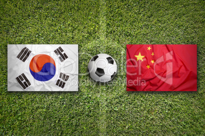 South Korea vs. China flags on soccer field