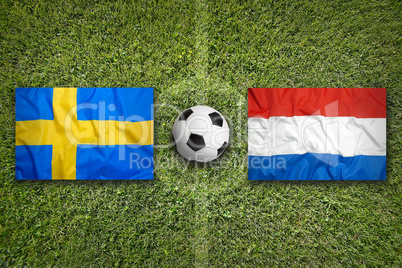 Sweden vs. Netherlands flags on soccer field