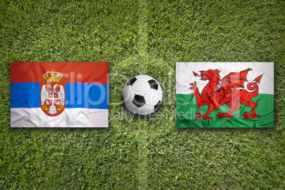 Serbia vs. Wales flags on soccer field