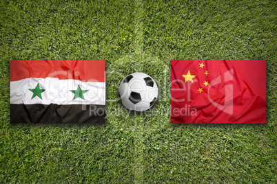 Syria vs. China flags on soccer field