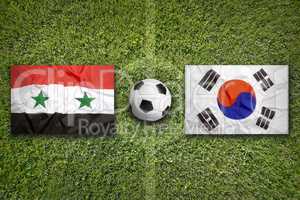 Syria vs. South Korea flags on soccer field