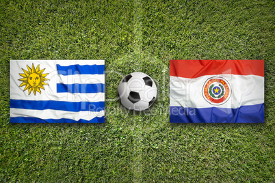 Uruguay vs. Paraguay flags on soccer field