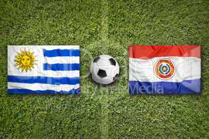 Uruguay vs. Paraguay flags on soccer field