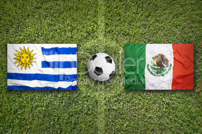 Uruguay vs. Mexico flags on soccer field