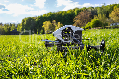 Dron is located in the green grass before takeoff