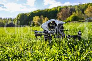 Dron is located in the green grass before takeoff