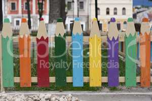 Wooden fence in the form of colorful pencils photo