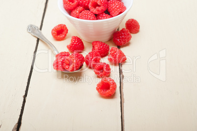 bunch of fresh raspberry on a bowl and white table