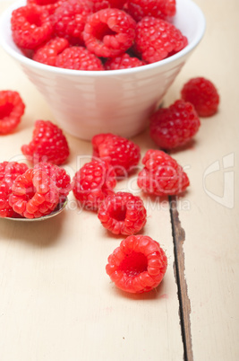 bunch of fresh raspberry on a bowl and white table