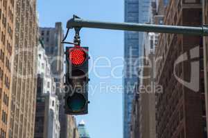 Traffic light on the background of skyscrapers in New York