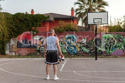 Basketball player in city playground