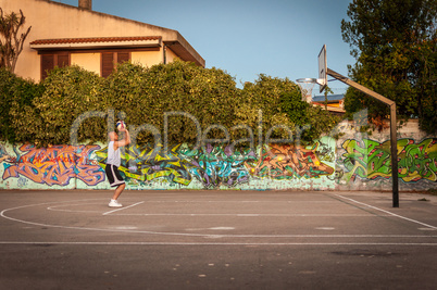 Basketball player in city playground