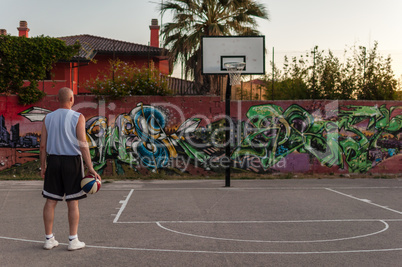 Basketball player in city playground